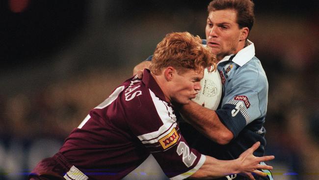 RL player Jamie Ainscough (ball) tackled by Brett Dallas during game 2 of NSW v Queensland 1997 ARL State of Origin series at MCG, 11/06/97. Rugby League A/CT