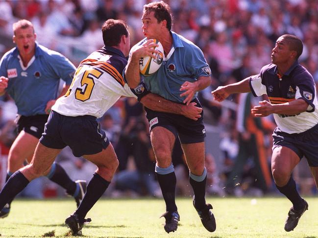 Tombs hits the ball up against the Brumbies at the SFS in 1996.