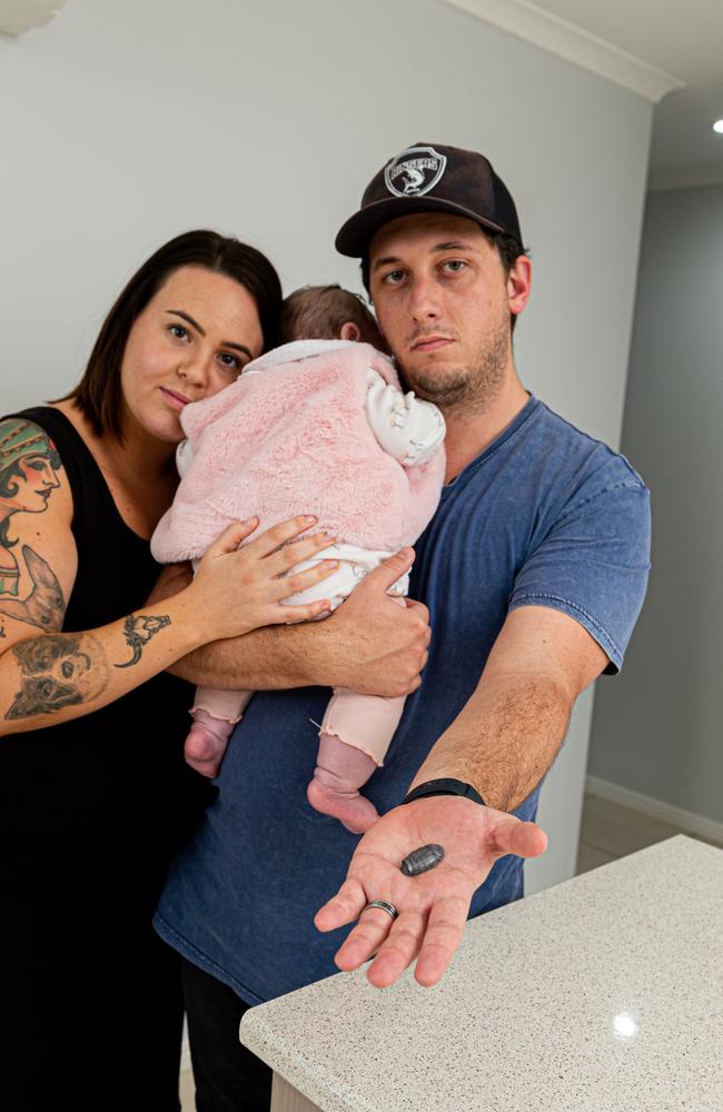 Keeping her close: Matthew Gardner holds the bullet that interrupted his quiet night in with fiancee Tenika Lawther and baby girl, Oceana. Picture: Paul Beutel