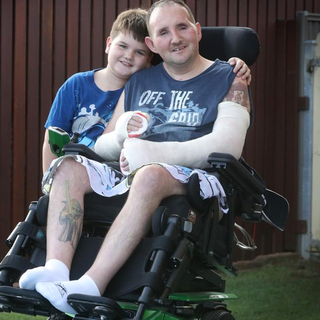 Mark Green, pictured with his son Jenson, 7, was left with a severe brain injury after an airbag exploded on a bus on which he was working. Picture: Jamie Hanson