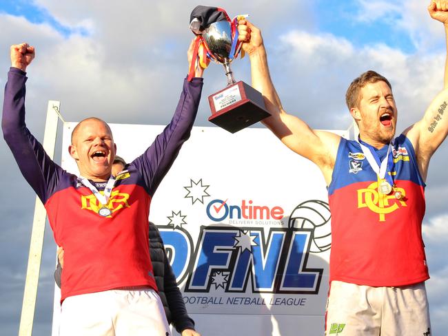 Diggers Rest coach Jamie Lobb and captain Tom Gleeson raise the premiership cup. Picture: Aaron Cook