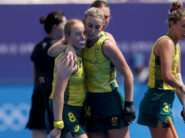 Maddison Brooks (left) is congratulated after scoring at goal at the Olympics. (Photo by Michael Reaves/Getty Images)