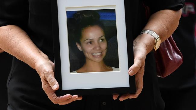 A supporter of Tara Brown’s family holds a photo of the murdered woman outside court in Brisbane today. Picture: Dan Peled/AAP