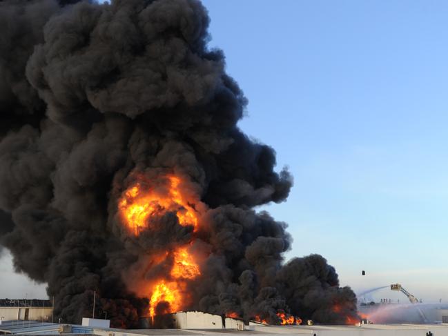 An out of control fire rages through factories around Thornycroft Street Campbellfield. Picture: Andrew Henshaw