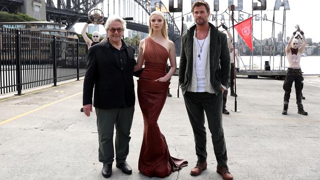 Director George Miller posing with stars Taylor-Joy and Hemsworth at the Passenger Terminal, Circular Quay. Photo by Brendon Thorne/Getty Images.