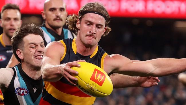 ADELAIDE, AUSTRALIA - AUGUST 20: Sam Berry of the Crows is tackled by Zak Butters of the Power during the 2022 AFL Round 23 match between the Port Adelaide Power and the Adelaide Crows at Adelaide Oval on August 20, 2022 in Adelaide, Australia. (Photo by Sarah Reed/AFL Photos via Getty Images)