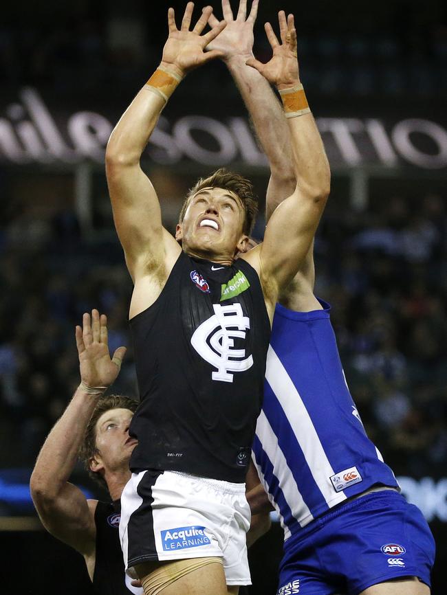 Patrick Cripps goes third man up against North Melbourne's Todd Goldstein Picture: George Salpigtidis