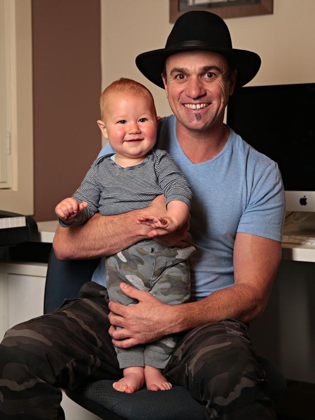 Australian singer Shannon Noll, with baby son Colton, is one of the headline acts at this year’s Torrens Transit Carols by Candlelight in Elder Park. Photographer: Adam Yip