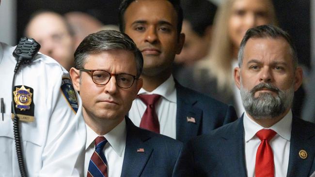 (L-R) US Speaker of the House Mike Johnson, former presidential candidate Vivek Ramaswamy and US Representative Cory Mills, Republican of Florida, listen as former President Donald Trump speaks to reporters as he arrives to attend his trial on Tuesday. (Photo by JUSTIN LANE / POOL / AFP)