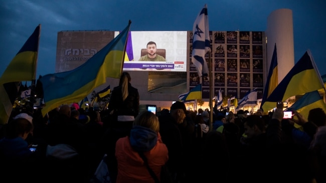Ukrainian President Volodymyr Zelensky addressing the Israeli government with locals watching on in support. Picture: Getty Images
