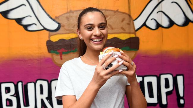 Andrea Iacovou enjoys a burger. Picture: Julian Smith