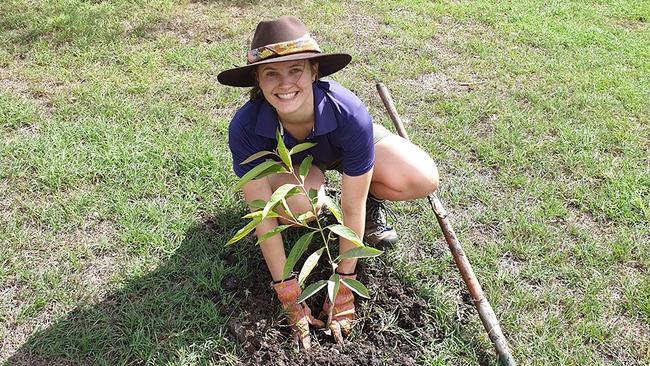 Research Assistant Teghan Collingwood from The University of Queensland planting a native guava (Rhodomyrtus psidioides) in a garden in Toowoomba, QLD. Photo: Rod Fensham