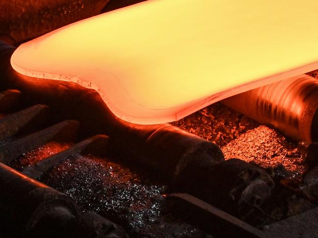 This general view shows steel moving along rollers at the hot rolling mill (rough rolling) during a media tour by Japanese company Nippon Steel at their East Nippon Works Kashima Area facility in Kashima, Ibaraki prefecture, north of Tokyo on December 6, 2024. (Photo by Richard A. Brooks / AFP)