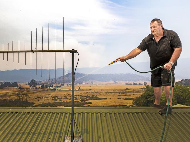 Fingal resident Tony Verren prepares for the fire. Picture: CHRIS KIDD