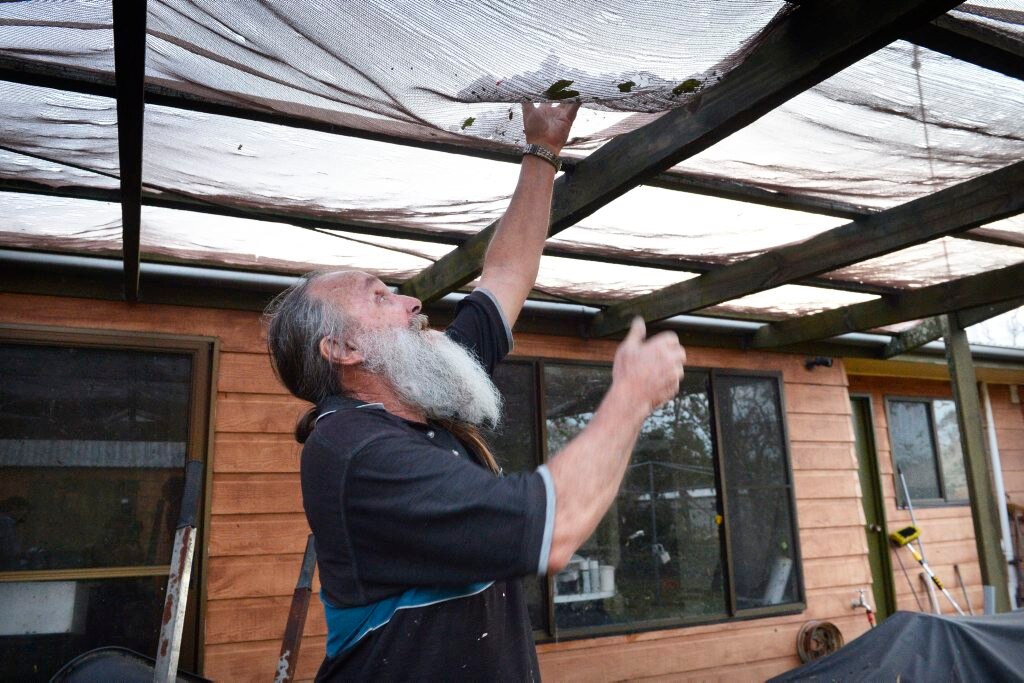 Fernvale resident Phill Anderson with some of the hail still at his house an hour after the storm. Photo Inga Williams / The Queensland Times. Picture: Inga Williams