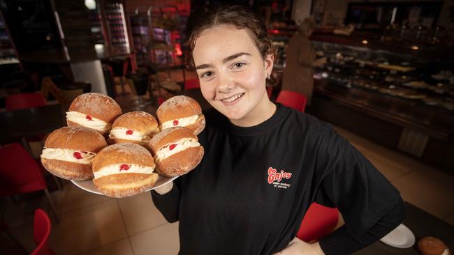 Norwood’s Enjoy Cafe Bakery worker, Stella Glynn, holding a plate of their popular Kitchener buns. Picture: Emma Brasier