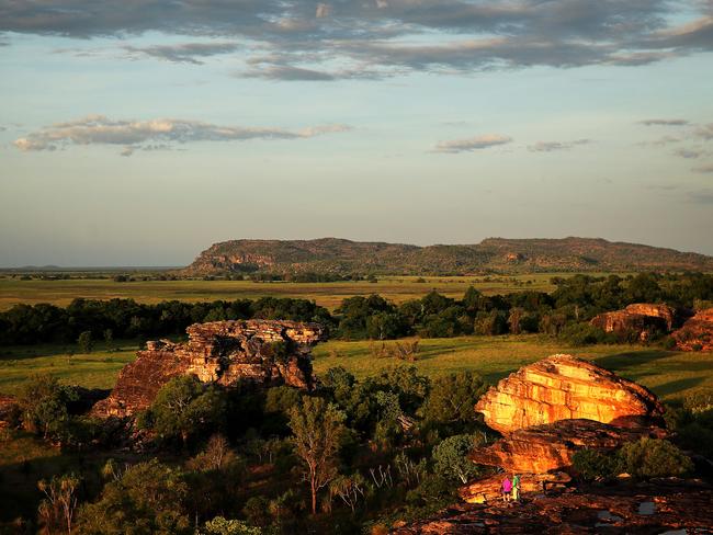 Two tourists take in the beautiful landscape below Ubirr rock in Kakadu