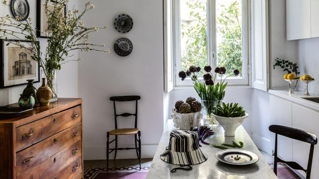 The kitchen inside the Seymour and Talianis apartment in Milan, with a hat by Rovi Lucca, the couples lifestyle label on the marble table. Picture: Robyn Lea