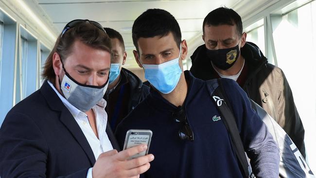 A man takes a selfie with Serbian tennis player Novak Djokovic as he arrives back in Serbia, after being deported from Australia. Picture: Christopher Pike/Reuters