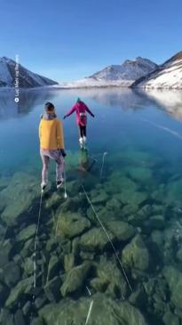 Ice skaters capture unreal footage gliding over frozen lake