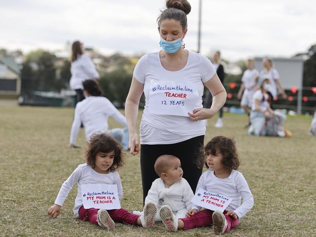 A protester attends the rally with her children. Picture: Alex Coppel