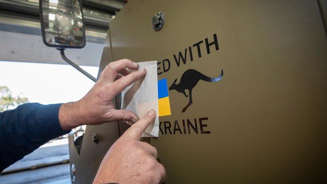 The "United with Ukraine" decal is applied onto the first of fourteen M113AS4 Armoured Personnel Carriers bound for Ukraine at Joint Logistics Unit â South Queensland, RAAF Base Amberley. *** Local Caption *** At the request of the Government of Ukraine, Australia has agreed to provide further defensive capability to protect Ukrainian soldiers and support Ukraineâs response to Russiaâs unrelenting and illegal aggression, even as Russia suffers set-backs. At the request of the Government of Ukraine, is gifting 14 M113AS4 Armoured Personnel Carriers and 20 more Bushmaster Protected Mobility Vehicles. Coming from current ADF stocks, the M113AS4 Armoured Personnel Carrier is a longstanding in-service ADF armoured fighting vehicle, and along with the Bushmaster Protected Mobility Vehicle, provides Ukrainian forces with a proven and effective capability to transport infantry soldiers on the battlefield. The gifted vehicles also join 60 pallets of medical supplies donated by Australian citizens and radiation monitoring radiation monitoring equipment and personal protective equipment, and personal protective equipment. Australiaâs current support to the Government of Ukraine has included the gifting of six M777 155mm lightweight towed howitzers plus ammunition, 20 Bushmaster Protected Mobility Vehicles, including 14 Protected Weapons Systems; anti-armour weapons and ammunition, body armour and cold weather clothing, combat rations, medical supplies and financial contributions to NATOâs trust fund for the Ukraine.