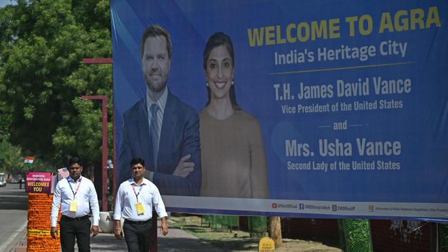Security personnel walk past a poster welcoming JD Vance and his wife Usha Vance to Agra. Picture: AFP