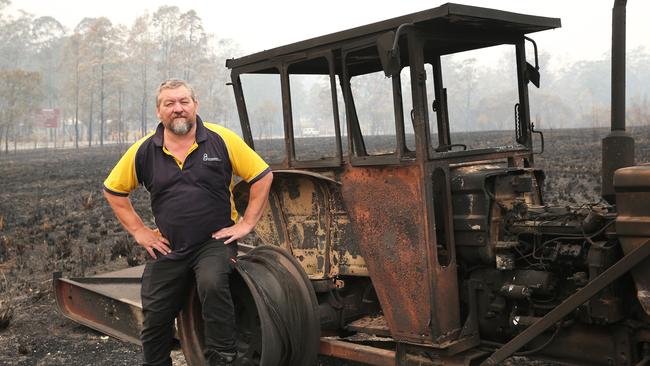 Rainbow Flat farmer Garry May with his burnt out Fiat 550 and brand new slasher. Picture: Peter Lorimer