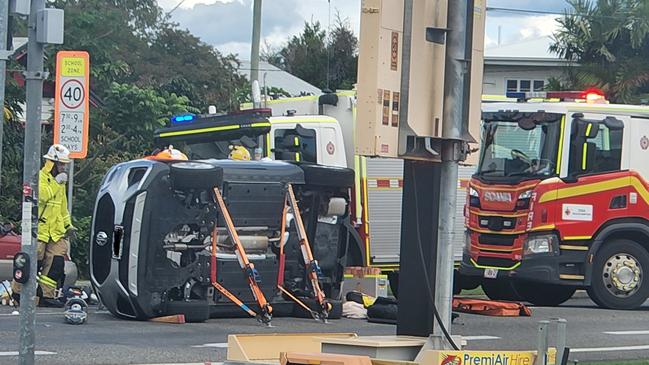 Emergency crews work to free a person from an overturned car in Park Avenue, North Rockhampton, on April 21. Photo: Darryn Nufer.