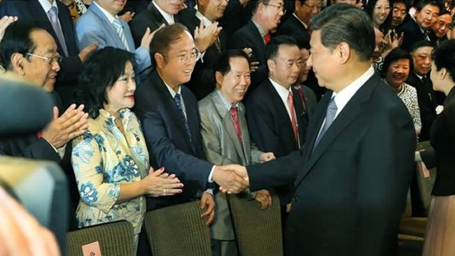 Huang Xiangmo shakes hands with China President Xi Jinping in Sydney.