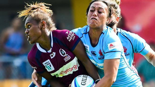 Queensland winger Ivania Wong wrapped up by the NSW defence at Leichhardt Oval last weekend. Alex Sulusi says she the game is making rapid improvements. Photo: Stu Walmsley, Rugby Australia