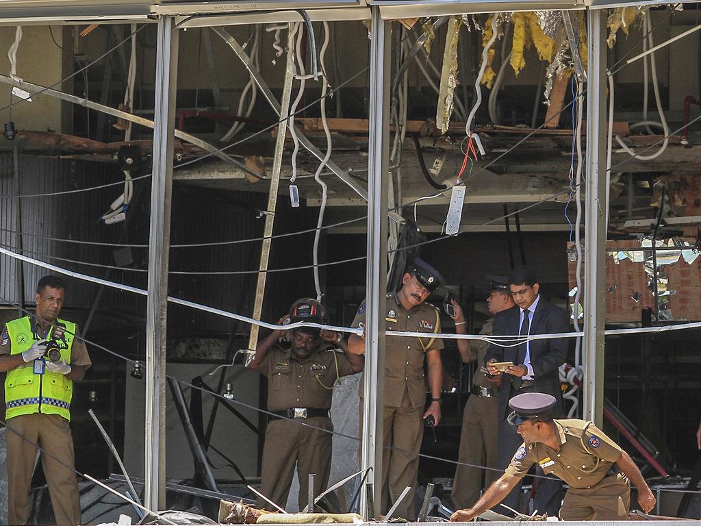 Sri Lankan Police officers inspect a blast spot at the Shangri-la hotel in Colombo, Sri Lanka where international tourists were killed by a terrorist bomb blast. Picture: AP Photo