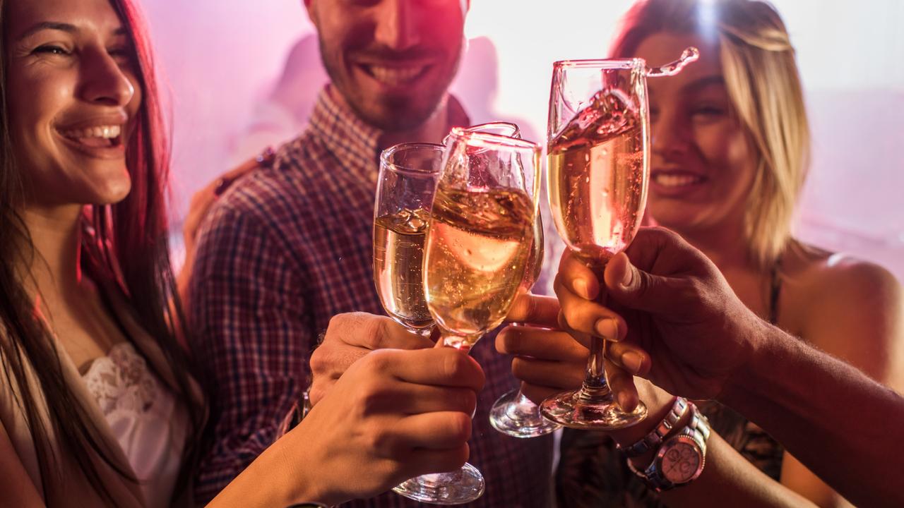 File image of group of young people celebrating and toasting with Champagne during the night out.