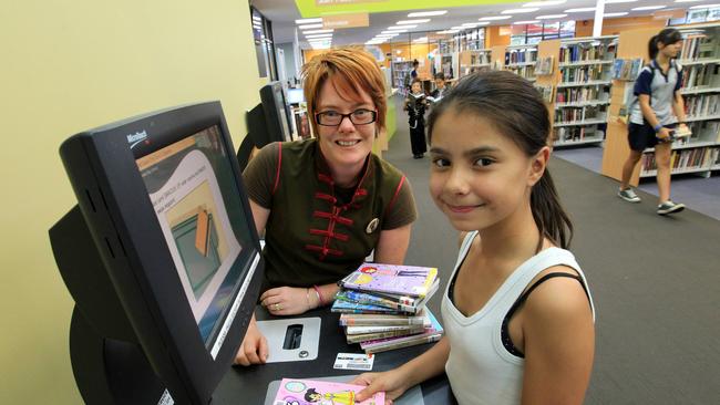 Library Assistant Sophie Gow and Gabrielle Vidakovic at Runaway Bay Branch Library. the library will be temporarily closed due to damages from storms on the Gold Coast.