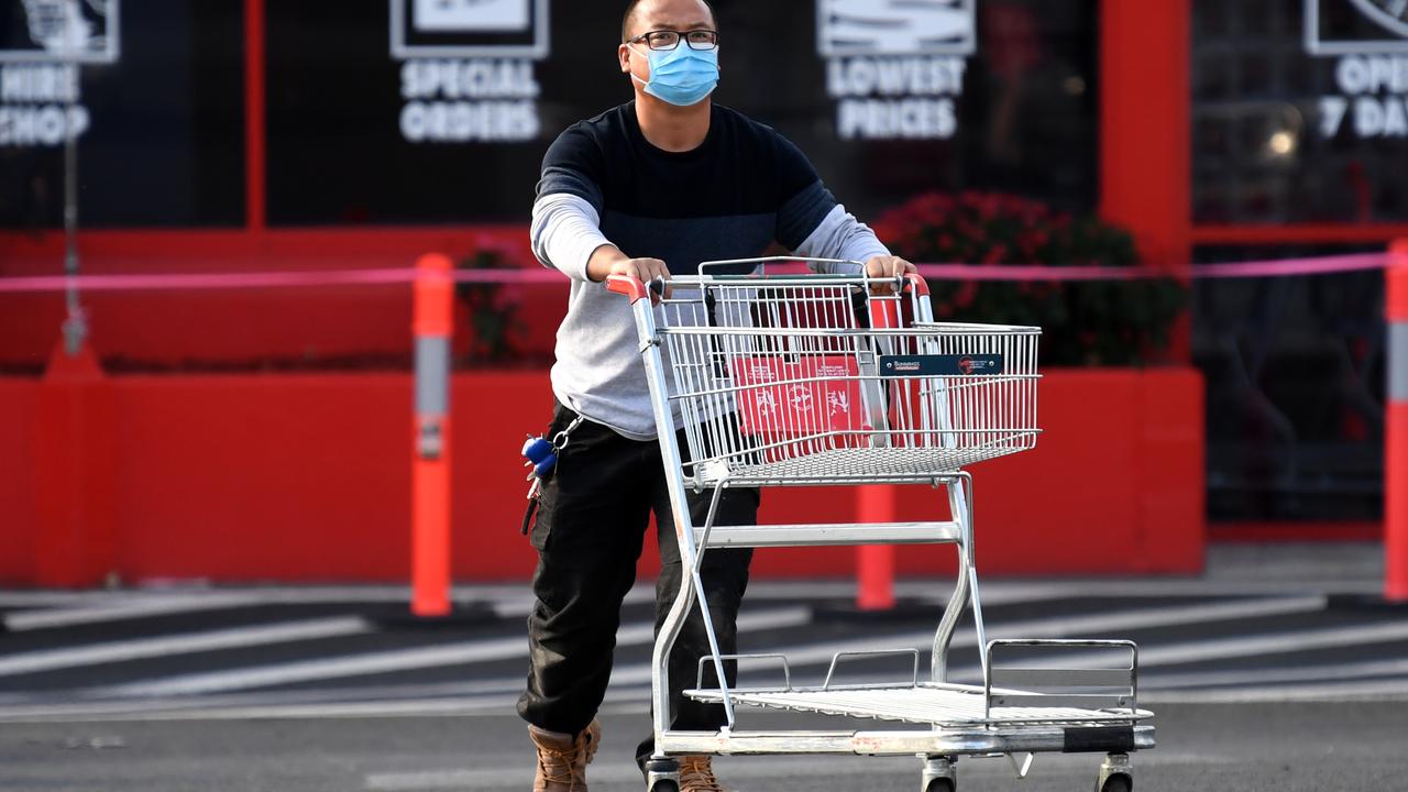 A masked customer leaves a Brisbane Bunnings. Picture: Dan Peled/NCA NewsWire