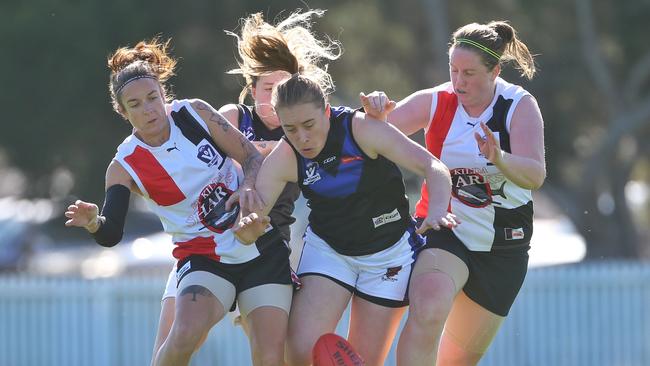 Jessica Anderson (centre) of Melbourne Uni under pressure from Mia-Rae Clifford (left) and Penny Cula-Reid of St Kilda.  Picture: Hamish Blair