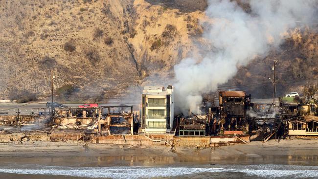 In this aerial view taken from a helicopter, burned homes are seen from above during the Palisades fire in Malibu, Los Angeles. Picture: AFP