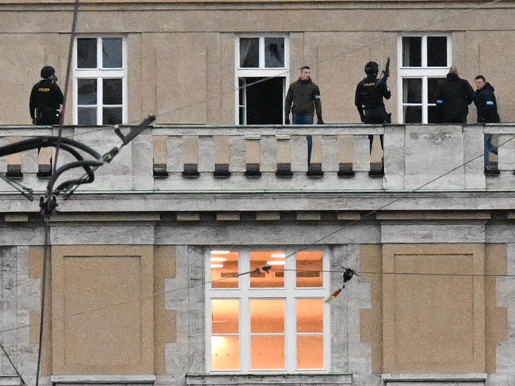 Armed police are seen on the balcony of the university in central Prague. Picture: Michal Cizek / AFP