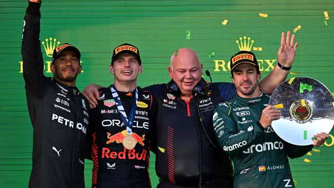 Hamilton, Verstappen and Fernando Alonso celebrate on the podium at the Australian Grand Prix. (Photo by Paul Crock/AFP)