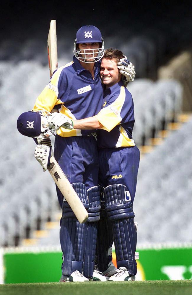 Ian Hewett, left, and Simon Dart embrace after a Victorian victory over NSW in the ING Cup in 2000.