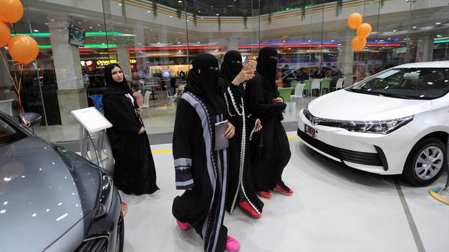 Tyre kicking: Saudi women tour a car showroom for women. By June, they hope they’ll be driving them. The showroom is staffed by women only. Picture: AFP