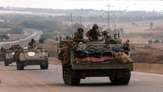 Israeli soliders ride in their armoured vehicles towards the border with the Gaza Strip on Monday. Picture: AFP