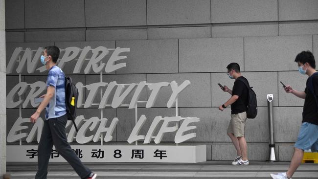 Employees walk outside the headquarters of ByteDance, the owner of video sharing app TikTok, in Beijing on Wednesday. Picture: Noel Celis/AFP