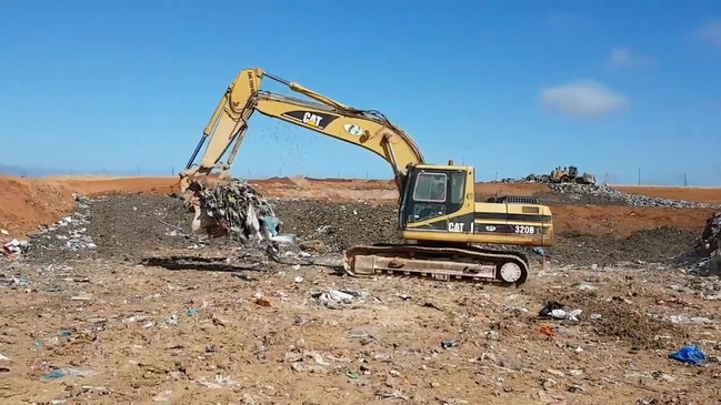 Police dig through rubbish for murder evidence