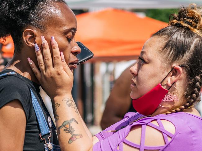 Kia Bible (R), comforts Mileesha Smith after a disturbance in the intersection of 38th Street and Chicago Ave in Minneapolis, Minnesota. Picture: Getty Images/AFP