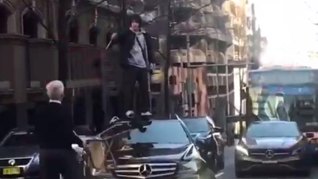 Ney was filmed jumping onto a car’s bonnet before he was arrested. Picture: Seven News