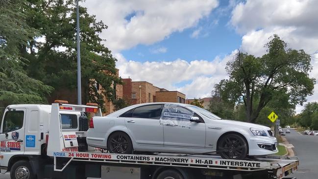 ACT police remove a bullet-riddled Holden Commodore from Manuka Oval. Picture: Craig Dunlop