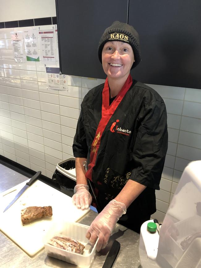 Amy Rigg slices Japanese barbecue pork for sushi rolls at Bendigo's iobento restaurant. Picture: Julieanne Strachan