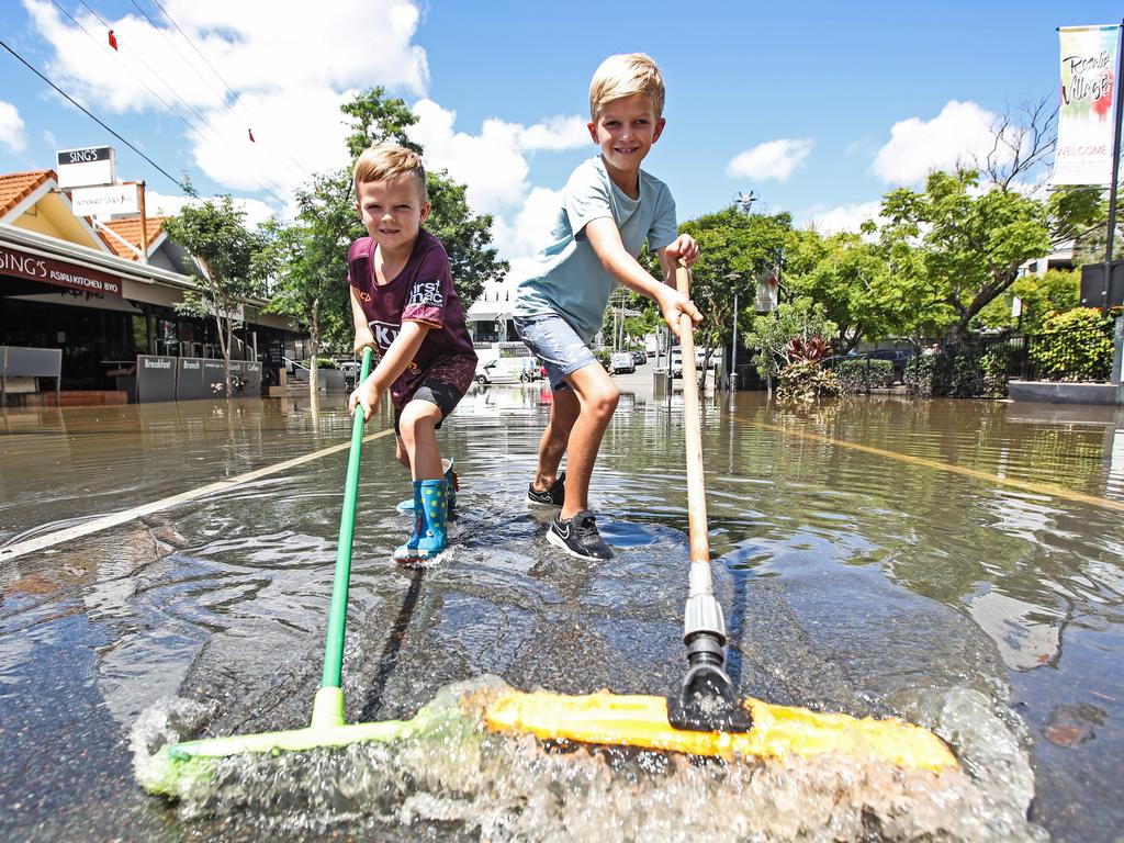 Kruze, 5, and Tyler Brigginshaw, 8, help clean up in Rosalie Village. Picture: Zak Simmonds