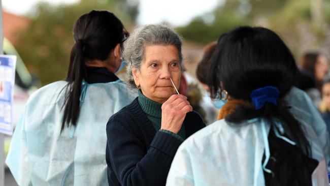 A woman self swabs at a coronavirus pop-up testing facility in Broadmeadows, Melbourne, on Friday.